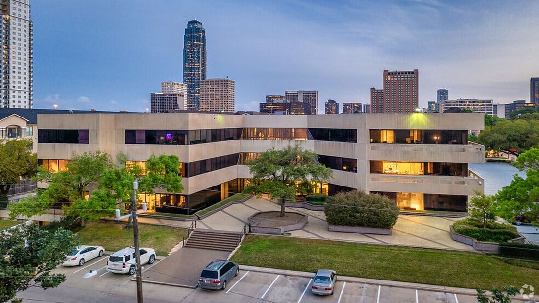 The Sage Park building at dusk with the Galleria skyline behind it