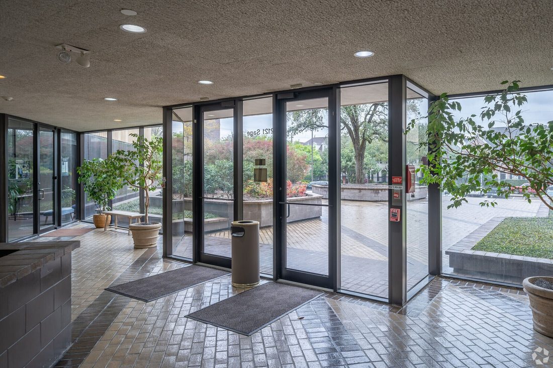 The glass lobby entrance of the Sage Park building